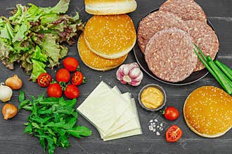 Burger patties. Beef cutlets, buns, vegetables and sauce. Homemade American classic