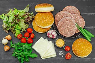 Burger patties. Beef cutlets, buns, vegetables and sauce. Homemade American classic