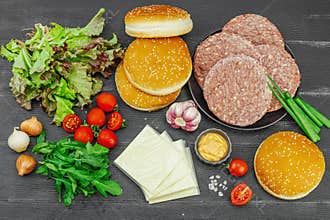 Burger patties. Beef cutlets, buns, vegetables and sauce. Homemade American classic