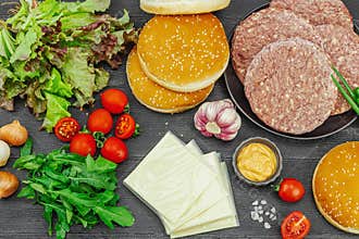 Burger patties. Beef cutlets, buns, vegetables and sauce. Homemade American classic