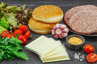 Burger patties. Beef cutlets, buns, vegetables and sauce. Homemade American classic