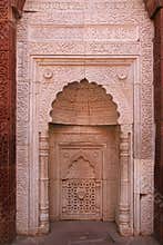 muslim monuments closed to an old stone minaret (qutb minar) in new delhi (india)