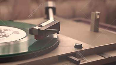 Green Vinyl Record on Spinning Gramophone Turntable and Cigar Smoke