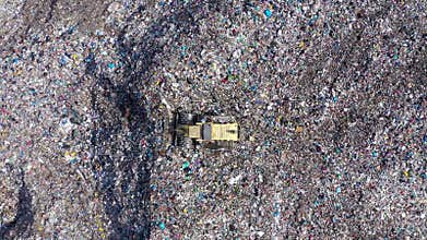 Slow motion view of large garbage pile, trash dump, landfill, waste dumping site aerial