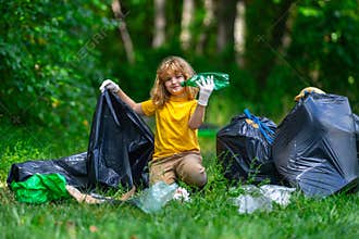 Child picking plastic trash for cleaning the nature. kid Clean up garbage outdoor. Ecology concept. Environment Day