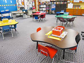 Organized kindergarten classroom with tables and chairs