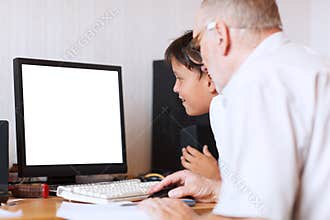 Grandfather and grandson in front of the computer