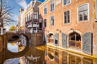 Historic buildings border a canal in Delft, the Netherlands