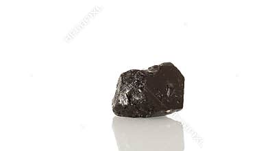 mineral stone Schorl rotates in a circle on a white background