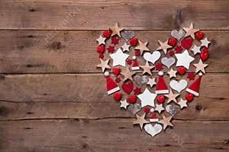 Christmas heart on a wooden background with different decoration