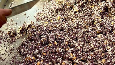 After frying, the crispy rice puffs are cut into bite-sized pieces and carefully packed into bags