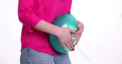 Woman is holding balloon feeling bloated