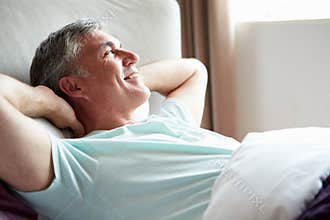 Middle Aged Man Waking Up In Bed
