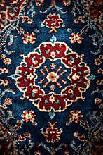 Persian rug with bold floral medallion and decorative borders
