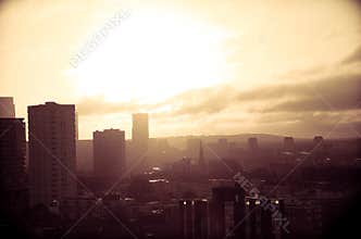Urban Sunrise or Sunset Over Silhouetted City Skyline