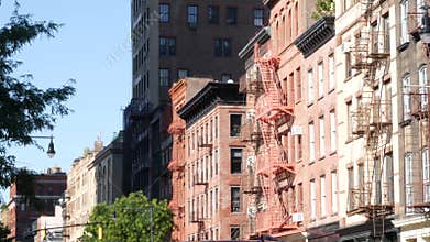 New York City building architecture, Manhattan. Residential house exterior. Red brick, fire escape.