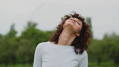 Beautiful lady wear white top starts workout with warmup. Young fit sports woman stretches her neck. Girl fitness