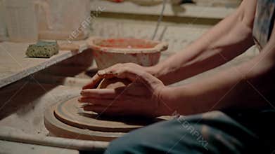 The master potter sticks a piece of clay and begins shaping next work. Concept of favorite hobby. Man spends much time