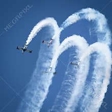 Stunt planes perform crowd pleasing stunts with smoke trails