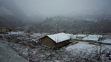 Snowfall in the Himalayas and House Shed Blanketed in Evening Snow