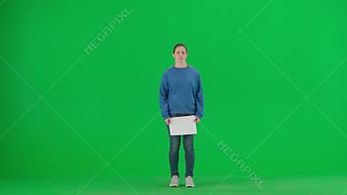 A young woman activist walks onto the green screen and holds a poster that says Let&#x27;s build a better world together