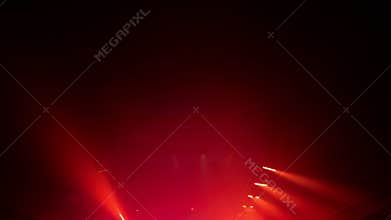 a colorful light show and a huge number of multicolored laser beams in a large indoor space