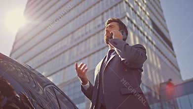 Busy manager calling partner at sunlight outdoors. Businessman talking phone