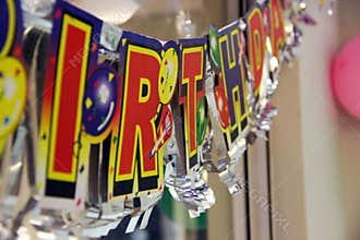 Detail of happy birthday banner in a real house