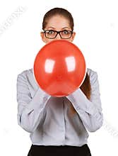 Girl inflating a large red balloon