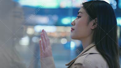 Charming Girl Leaning Against Glass Looking at an Exhibit. Portrait of a Young Girl Looking Through a Glass in a Museum