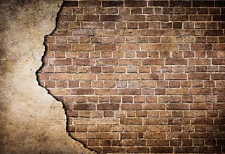 Old brick wall with stucco partially damaged
