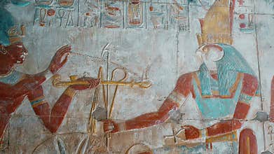 Ancient Egyptian hieroglyphs and bas-reliefs close-up in Temple of Seti I in Abydos, Egypt. Temple of Seti I