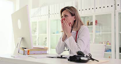 Sad woman doctor looking into computer screen and seeing bad result of analysis of patient in clinic 4k movie slow