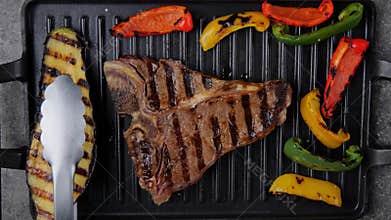 T- bone beef steak grill with vegetables on grill pan. Top view