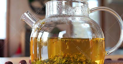 Freshly brewed slimming herbal tea in glass teapot. Beverage for those aspiring for slender figure. Experience benefits