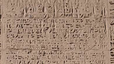 Ancient Egyptian hieroglyphs and bas-reliefs close-up in Temple of Medinet Habu. Egypt, Luxor. The Mortuary Temple of