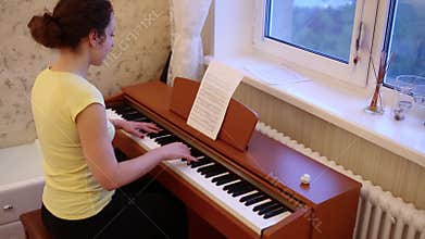 Young woman with curly hair is playing on the