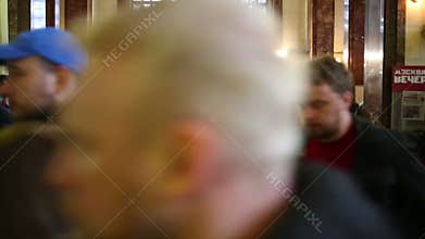 Many people go through the turnstiles in the