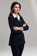 Confident professional in dress shirt, crossed arms, standing tall