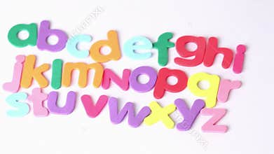 Multicolored letters arranged in three lines, one