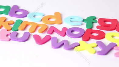 Multicolored letters arranged in three rows, in