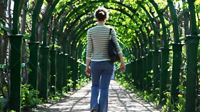 young woman leaves through arched corridor braided
