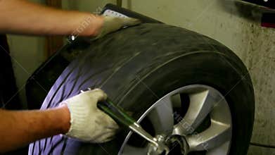 Man adjust balance of car wheel on special