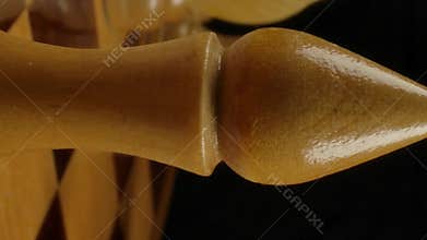 Vertical of Men's hand puts a bishop figure on checkerboard cell