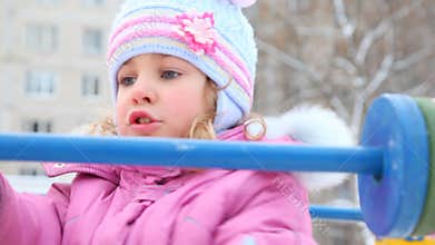 little girl playing with abacus in winter