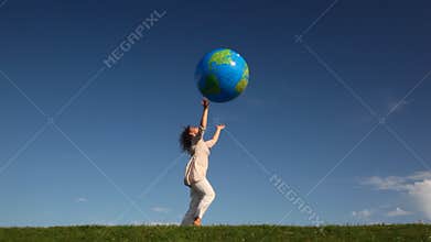 pretty young woman tosses large inflatable earth