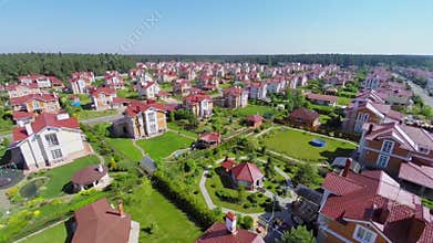 Gated development near forest at sunny summer day.