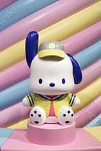 JAPAN - Apr 17, 2024: Pochacco cute cartoon floppy ears figure in baseball uniform on display a colorful pastel striped perfect