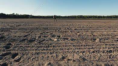 Wandering through Sunlit Sands: Hiker's Quest in Arid Wilderness