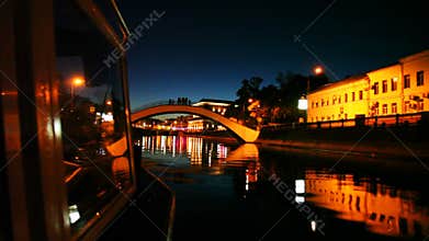 boat moves along Moscow River to small arched